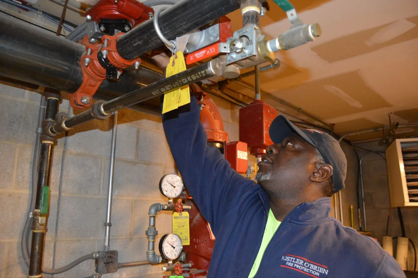 Man inspecting fire protection sprinkler system.